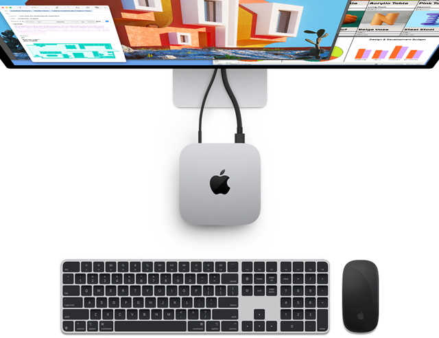 Dessus du Mac mini en finition argent avec le logo Apple, connecté à un moniteur et situé à côté d’un Magic Keyboard sans fil et d’une Magic Mouse